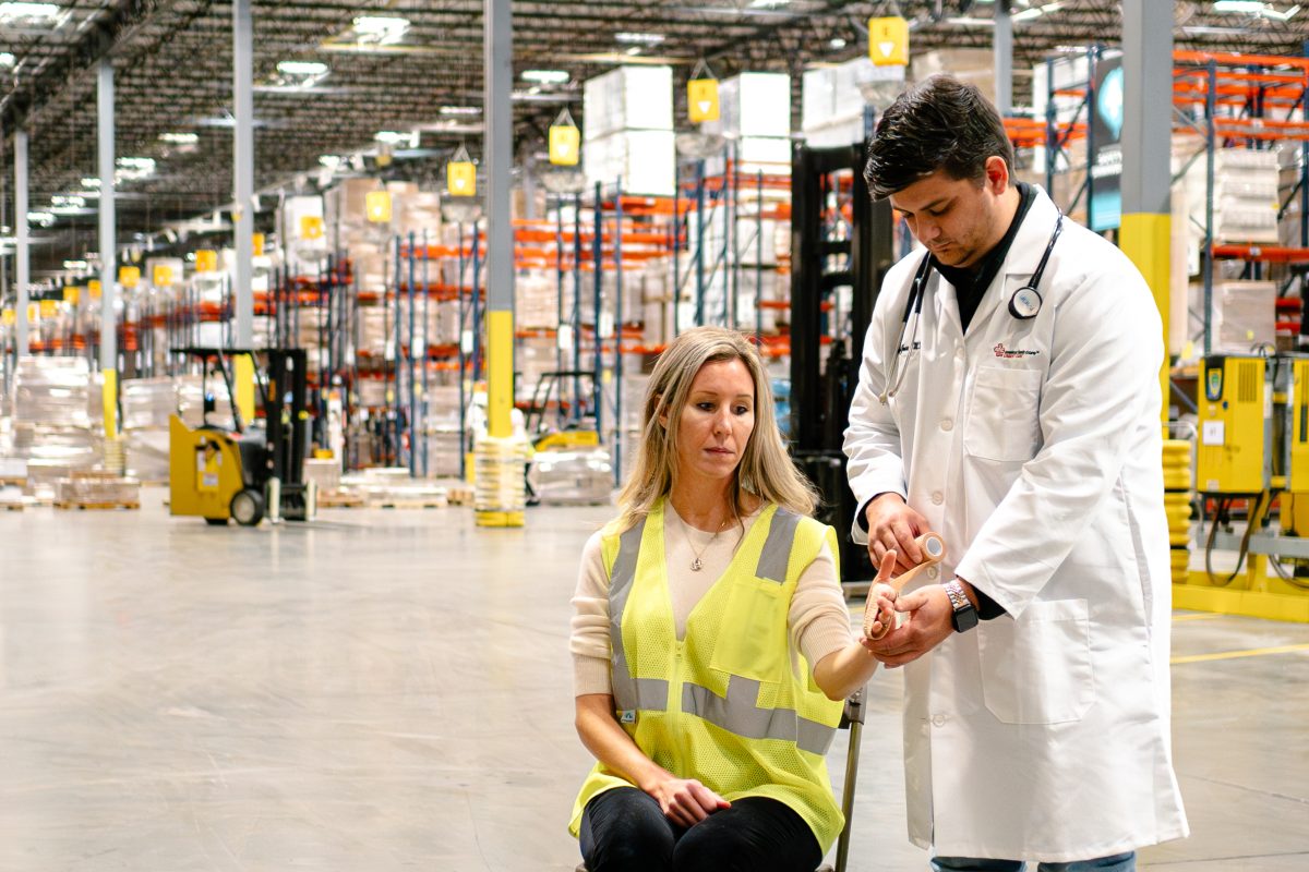 medical provider wrapping employee's hand after workplace injury medical provider wrapping employee's hand after workplace injury